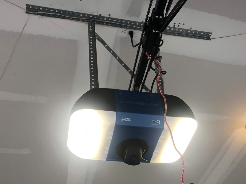 Technician replacing garage door rollers